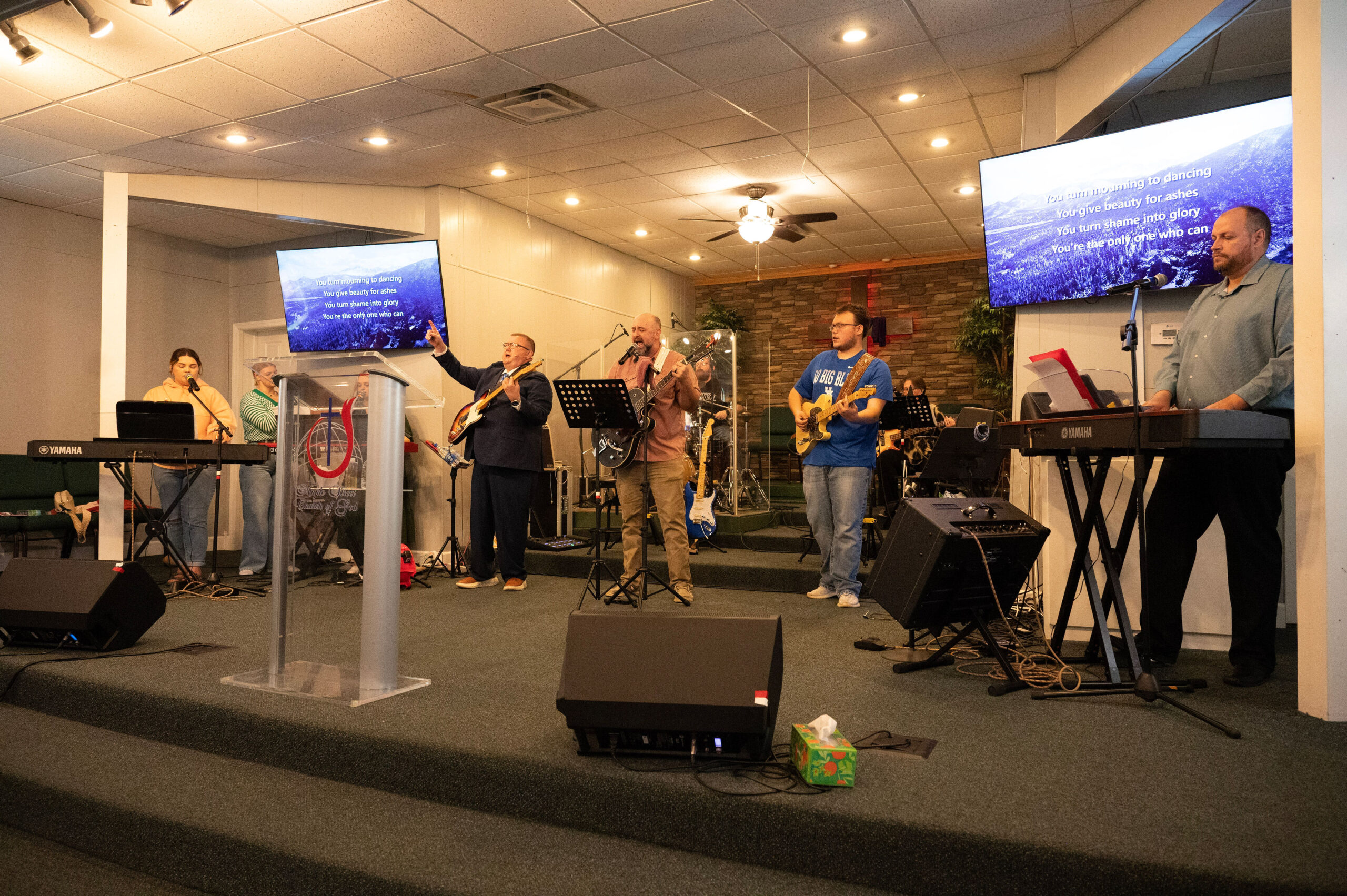 Maple Street worship team singing and playing guitars, drums, and keyboards