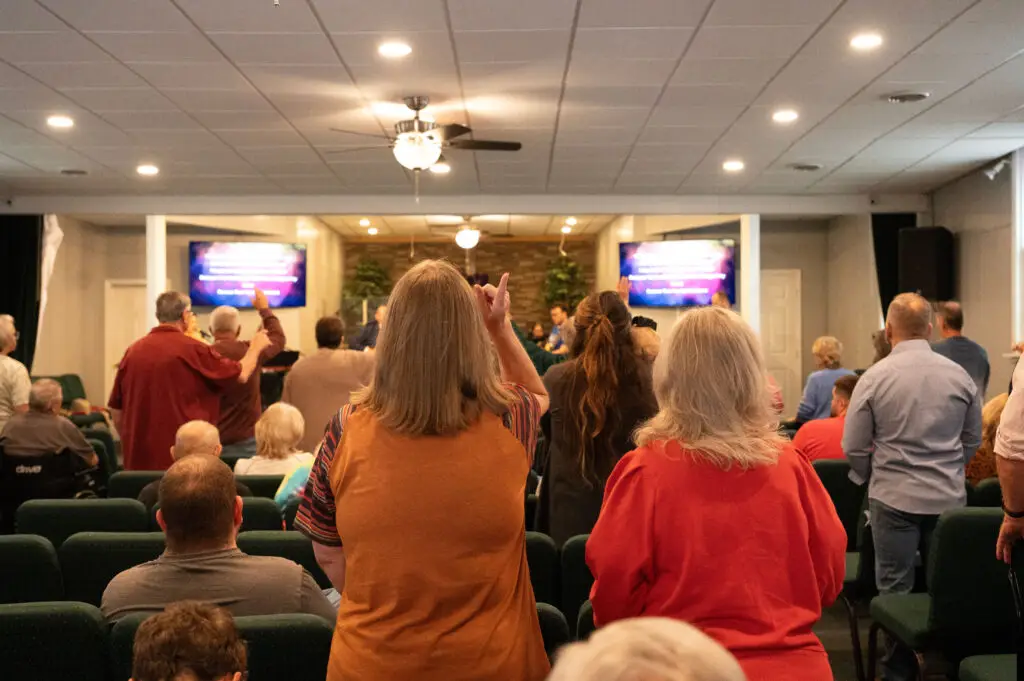 Congregation standing in worship at Maple Street Church of God