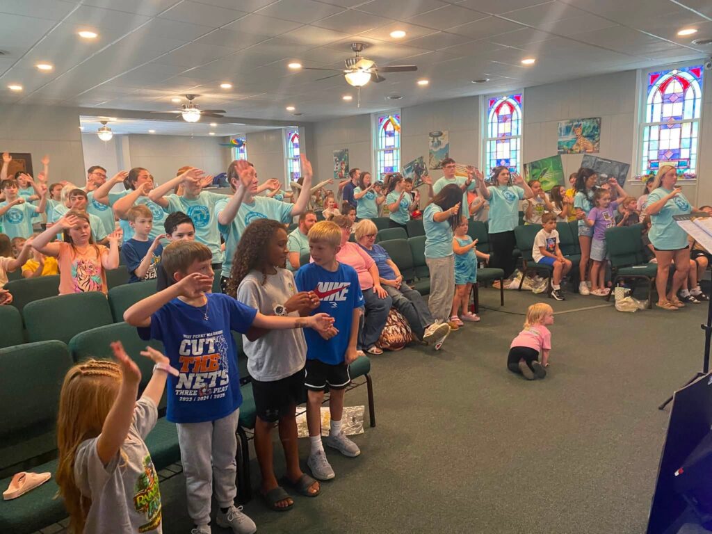 Children and leaders participating in Vacation Bible School worship in the sanctuary