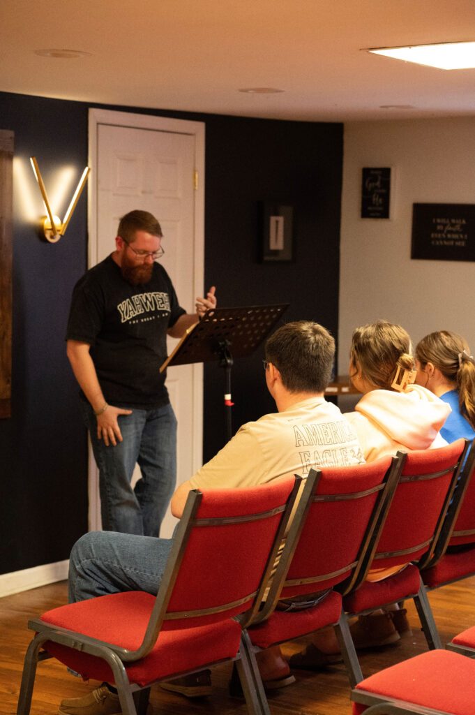 Youth leader teaching students seated in the Element 412 room