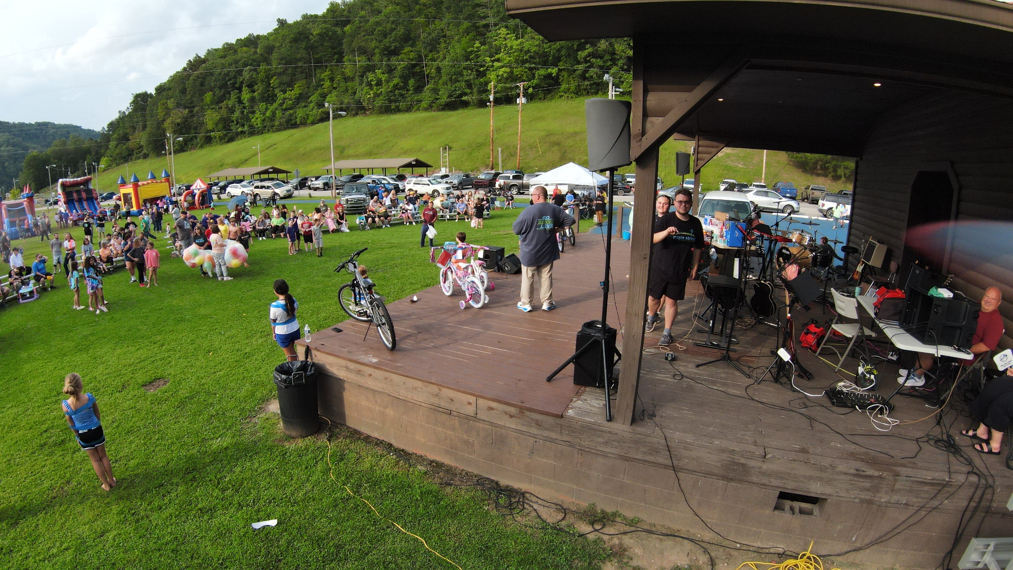 Families gathered around the outdoor stage with prizes and worship equipment at Takin’ it to the Streets