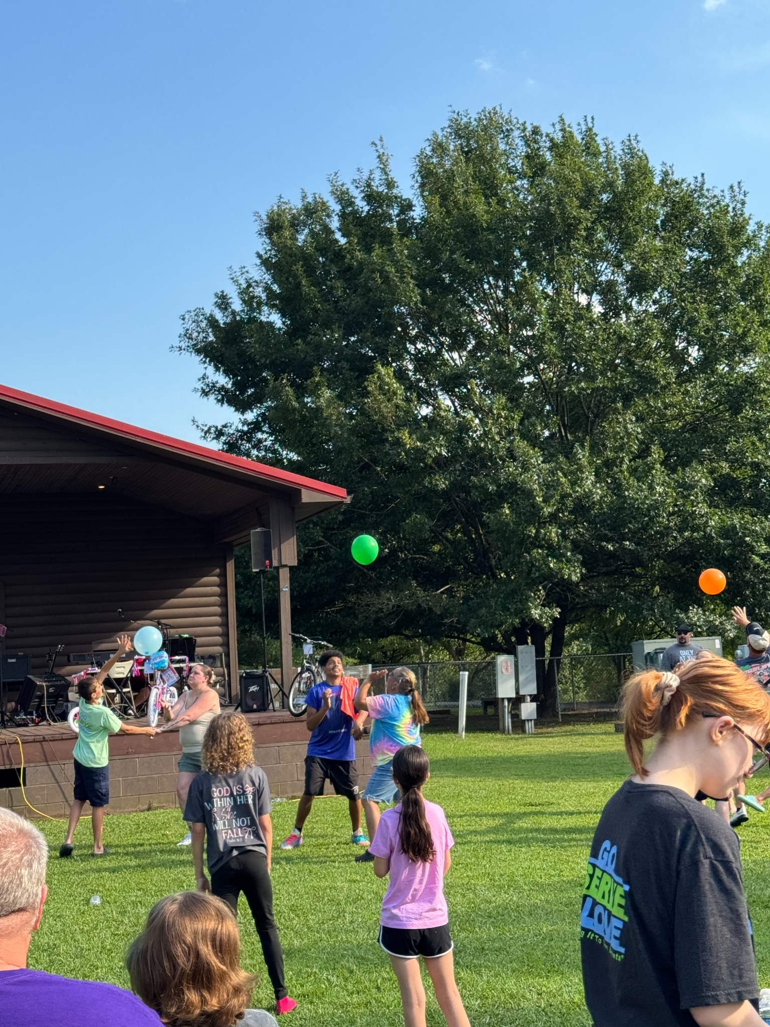 Children and families enjoying a balloon game at the outreach