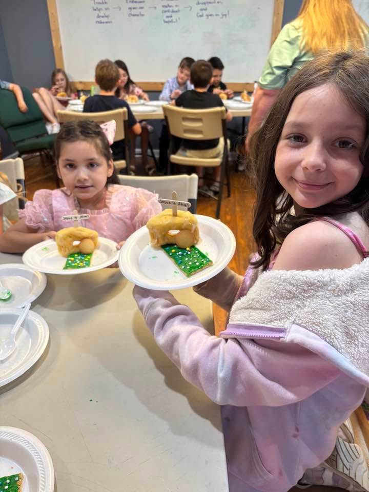 Two children showing their activity at Children’s Church