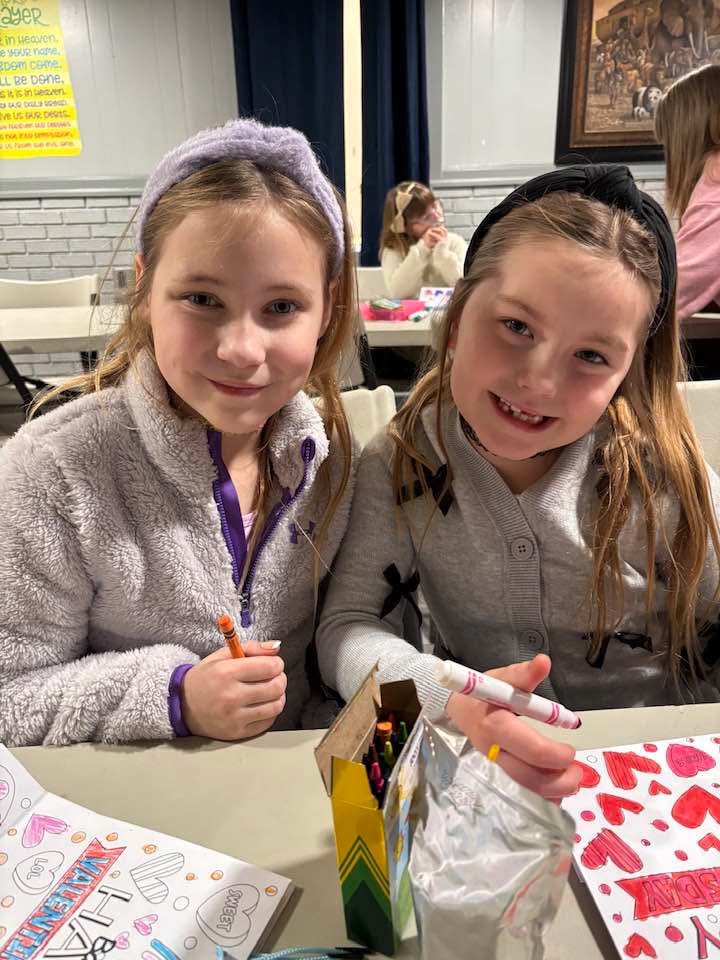 Two children smiling together at Children’s Church