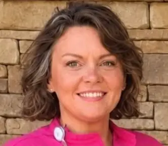 Portrait of a smiling woman in a pink shirt