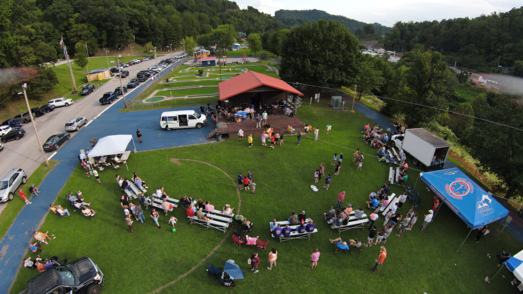 Aerial view of families gathered for an outdoor Maple Street community event
