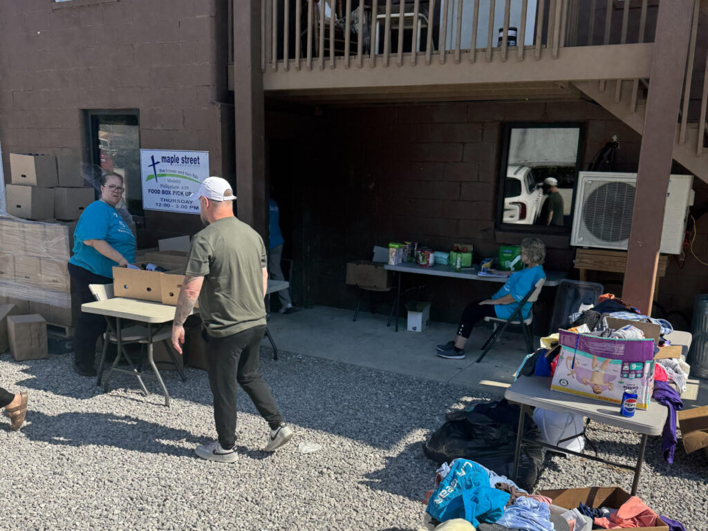 Food pantry volunteers distributing groceries outside the ministry building