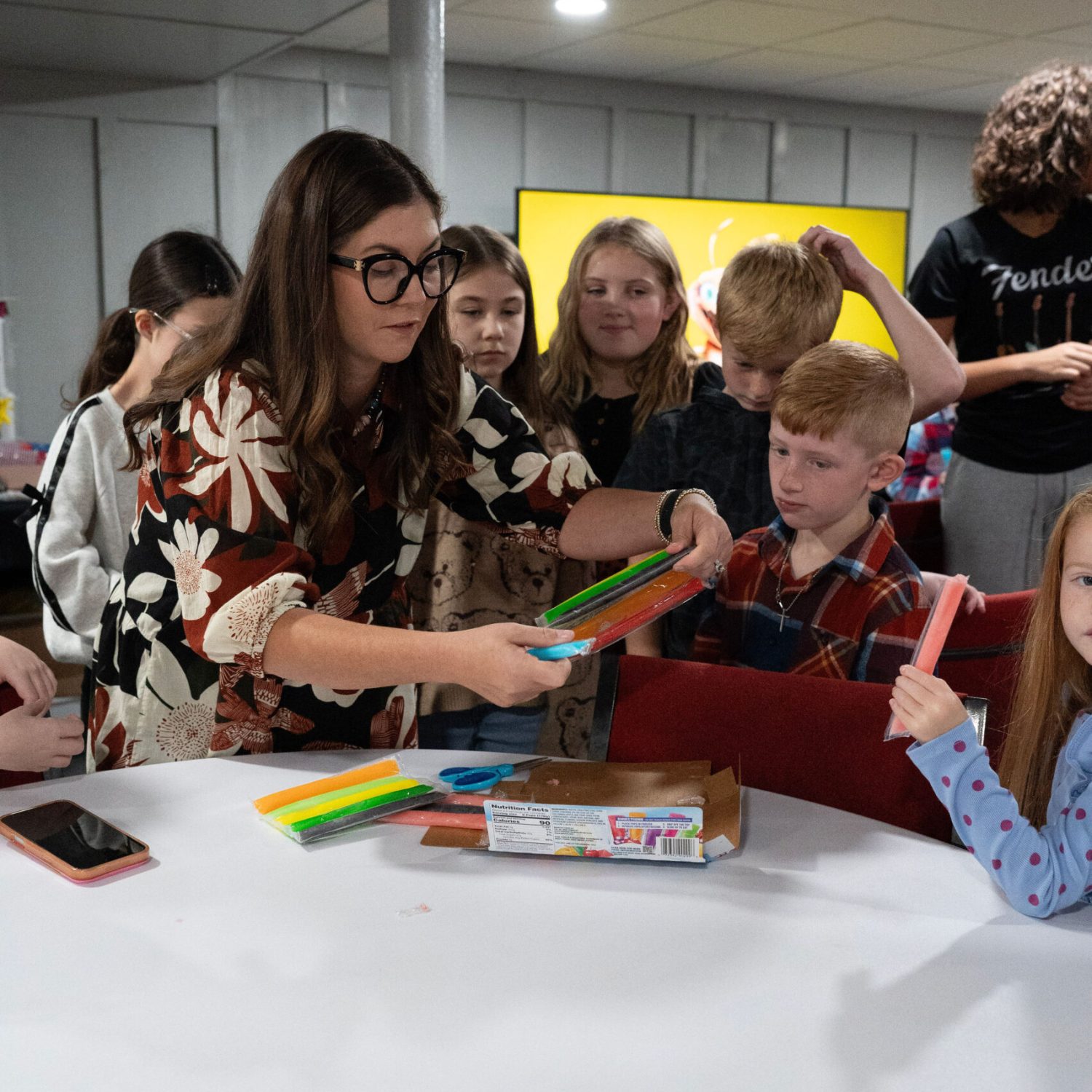 Children and a leader working on a colorful classroom activity